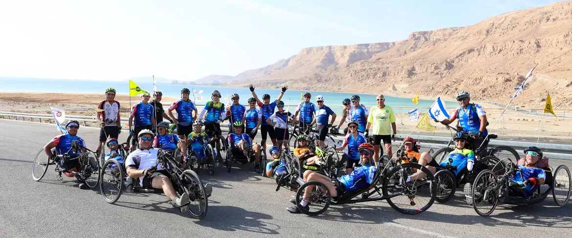 Handbikers and other riders at the Dead Sea